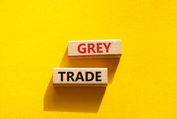 Grey trade symbol. Wooden blocks with words grey trade. Beautiful yellow background. Business and grey trade concept. Copy space.