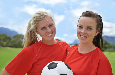 Best forwards in the league. Portrait of two young female soccer players standing on a soccer field.