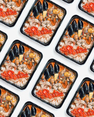 Frozen tom yum soup, semi-finished product in plastic packaging on white background. Spicy asian food for cooking home. Plastic package. Seafood and vegetables ingredients, photo pattern