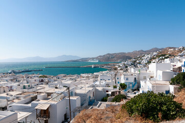 Panoramic view from the hill of Mykonos village and its coastline against the blue sky. Vacation travel concept