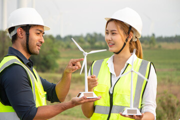 engineer team working in wind turbine farm. Renewable energy with wind generator by alternative energy concept.