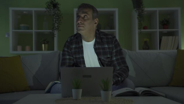 Man working from home is having a power outage.
Businessman is caught in a power outage at home in the evening.
