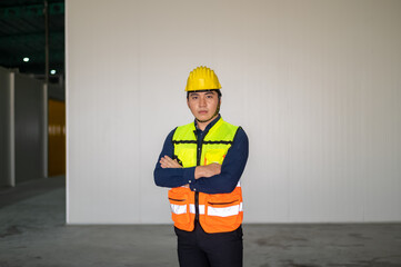 Asian people are engineer standing, Building sector and industrial workers concept. Confident young...
