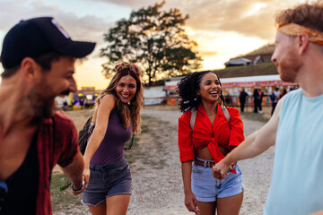 Happy young friends having fun at music festival