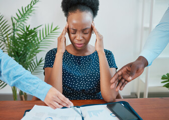 Young Black woman stressed at work due to paperwork and reports