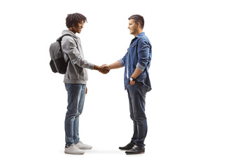 Full length profile shot of an african american male student and a caucasian man shaking hands