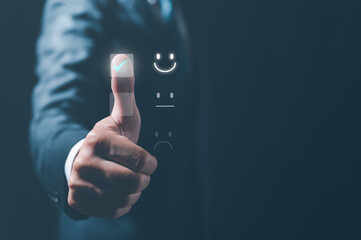 Customer service satisfaction survey concept.Business people or customers show satisfaction by pressing face emoticon smile in satisfaction on virtual touch screen.