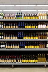 Fototapeta premium Beer bottles on shelf in supermarket with brand less labels. Suitable for presenting new beer bottles and new designs of labels among many others. 