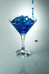 A Refreshing, deep blue drink in a conical glass