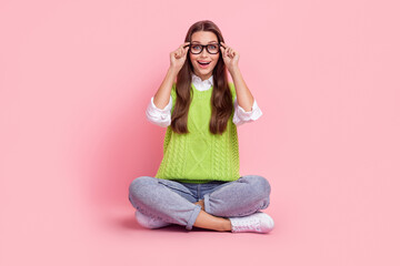 Full size photo of positive ecstatic woman wear green waistcoat jeans sneakers touching glasses staring isolated on pink color background