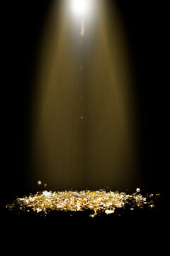 Sprinkle gold dust on a black background with copy space