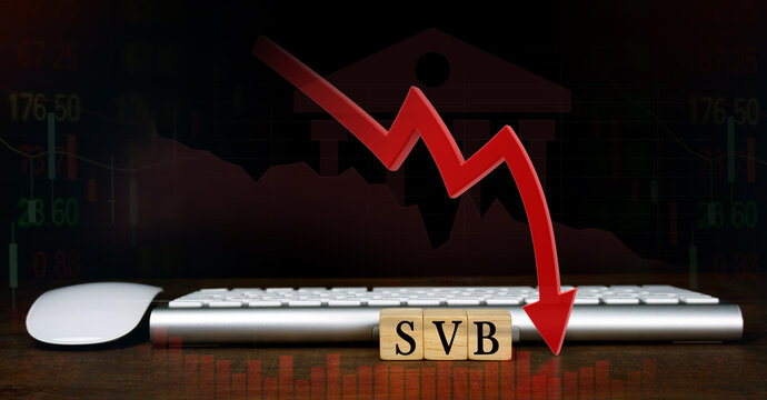 SVB (Silicon Valley Bank) with keyboard and mouse, stock market chart, and red arrow pointing down. biggest bank in Silicon Valley, stocks fall.