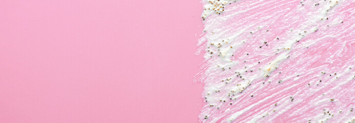 The texture of a cosmetic scrub. An exfoliating skin care product. Pink background. Copy space.