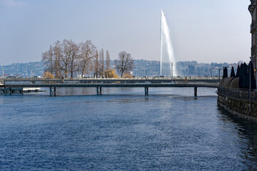 Rhone river with Mont Blanc Bridge and Lake Geneva in the background at Swiss City of Geneva on a sunny late winter day. Photo taken March 5th, 2023, Geneva, Switzerland.