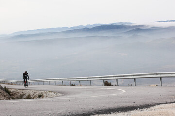 Ciclista na estrada em dia de nevoeiro