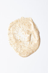 Sample cream scrub for washing with vitamin F. An exfoliating skin care product. White background