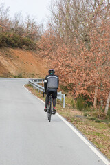 Ciclista a andar na estrada no outono