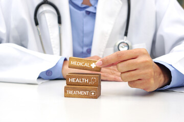 Hand holding a wooden block cube the top one with word and icon symbol. Medical and health concept.
