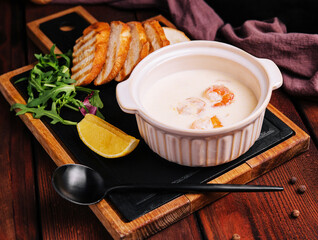Tasty cream soup with shrimp in bowl