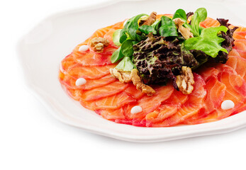 Salmon carpaccio with salad on plate