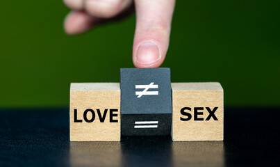 Symbol  that sex does not equal love. Hand turns cube and changes the equation 'love equal to sex' to 'love unequal to sex'.