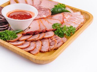 Assorted deli cold meats on wooden tray