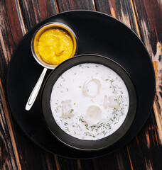 Cold soup okroshka on wooden background