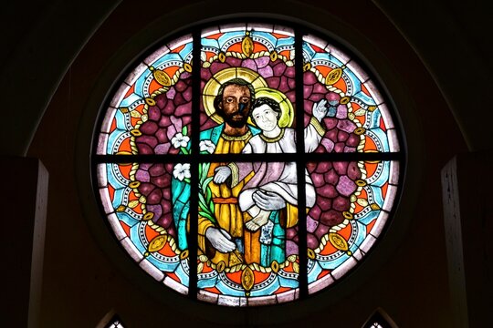 Saint Joseph holding Baby Jesus, stained-glass