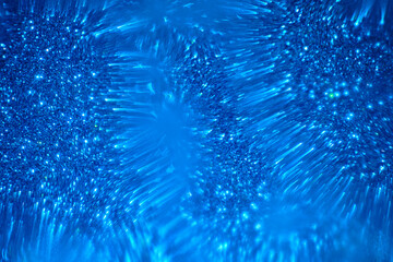 Abstract blue background with blurred shiny shapes.
