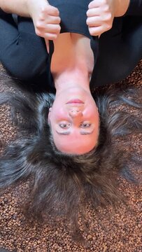 Beautiful portrait of sensual european young woman model tss sign with coffee and rustic bags lying down. High quality photo