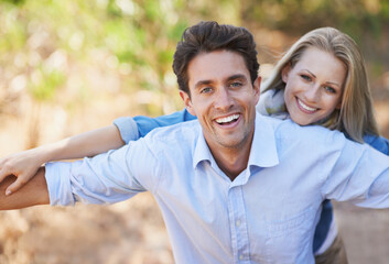 Were always laughing together. A young couple standing together with their arms outstretched in the outdoors.