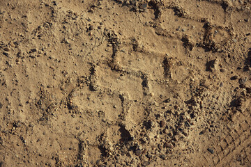 Dirt gravel road with tire tracks texture at the construction site