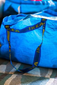 Closeup Shot Of A Blue Plastic Ikea Store Bag On A Carpet Floor.