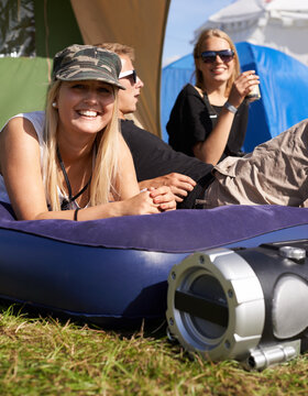 Camping Crew. A Young Woman Relaxing On A Blow Up Mattress At An Outdoor Festival.