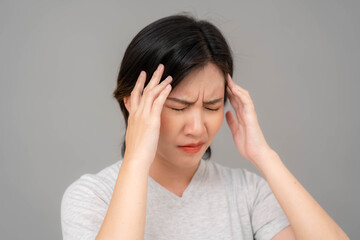 Asian woman holding her temple and making a bad face. woman having migraine headache