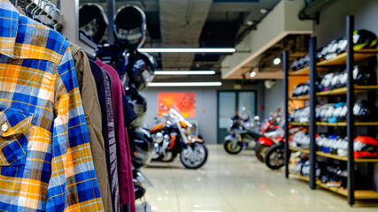 Inside the motorcycle store. Clothing, helmets, motorcycles. Focus on the foreground