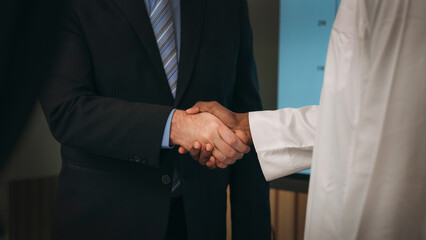 Fototapeta premium Business people handshake of partners at the office desk. Discussion among businesspeople on the latest developments.