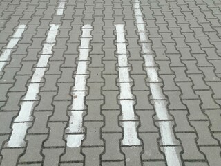 Fototapeta premium Closeup shot of white lines on a stone pavement outdoors