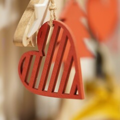 Closeup shot of a painted wooden heart Christmas tree ornament on a rope