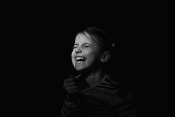 Fototapeta na wymiar Conceptual image : mental health, stress, depression, panic attacks and anxiety in children. Nervous young girl screams for help.. Black and white image.