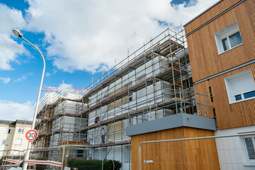Réhabilitation thermique de logements collectifs. Réfection de facades avec pose d'un  isolant et de bardage. Echafaudages