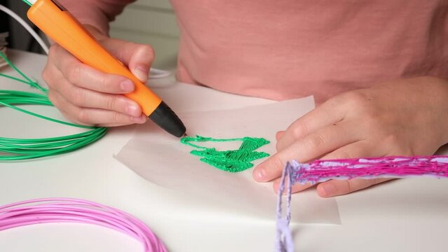 Teen Girl Using 3d Pen. Printing with Colored Plastic Wire Filament. Child making a Christmas Three, drawing with 3D pen. Artwork, Robotics. STEAM, STEM education. Modern Technologies. Study at home