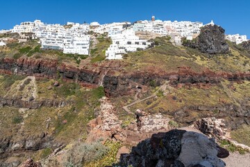Village of Imerovigli viewed from Skaros rock headland on a cliff in Santorini, Greece