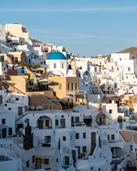 Oia Town in Santorini with  traditional Cycladic houses overlooking the Sea, Greece, vertical