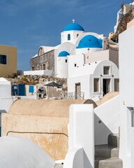 Vertical shot of old buildings in Santorini, Greece, on a sunny day