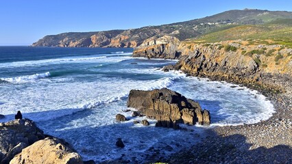 Wild place to relax on Abano beach with impressive cliffs in Sintra Cascais Natural Park, Portugal