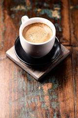 Cup of coffee on wooden background. Close up.	