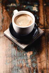 Cup of coffee on wooden background. Close up.	
