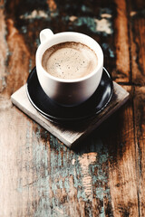 Cup of coffee on wooden background. Close up.	