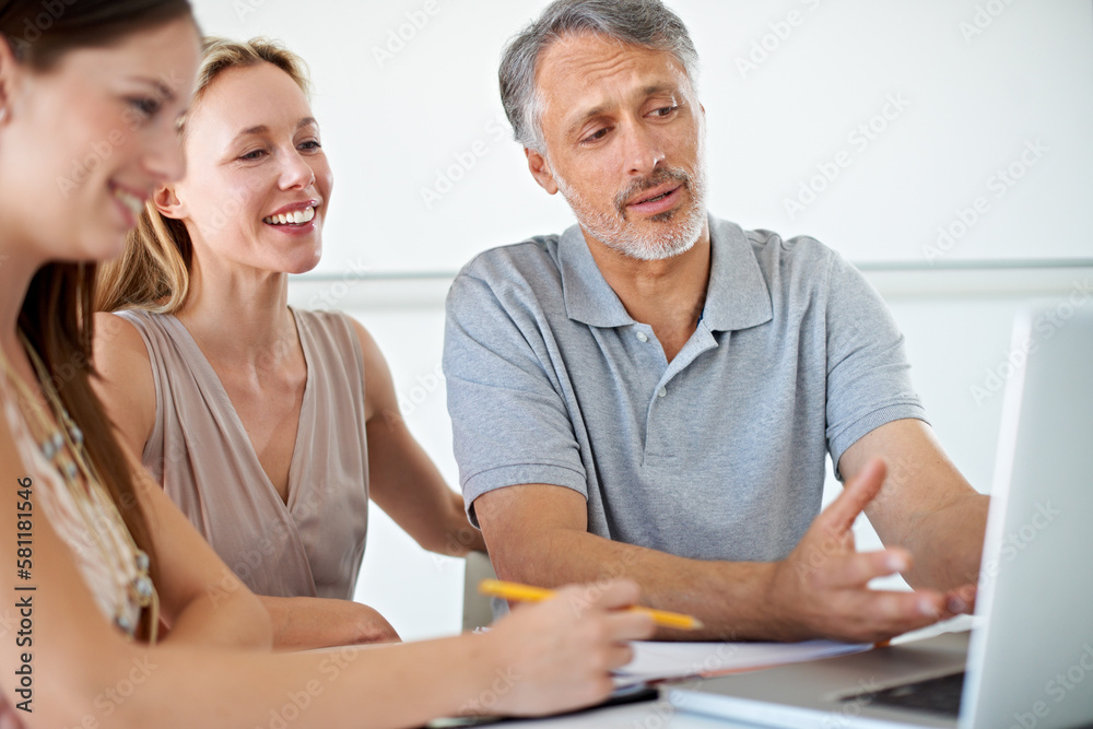 Canvas Prints Discussing what is best for our company. Three people working on a laptop together in the office.